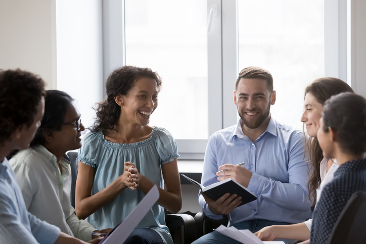 Smiling multiracial colleagues take part in motivational training at workplace The Importance of Life Skills Training in Addiction Recovery